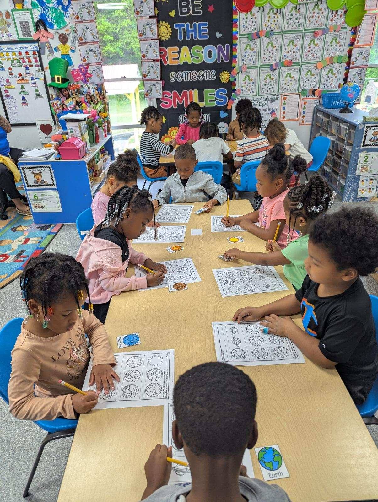 Children engaged in a hands-on learning activity at Falls Academy